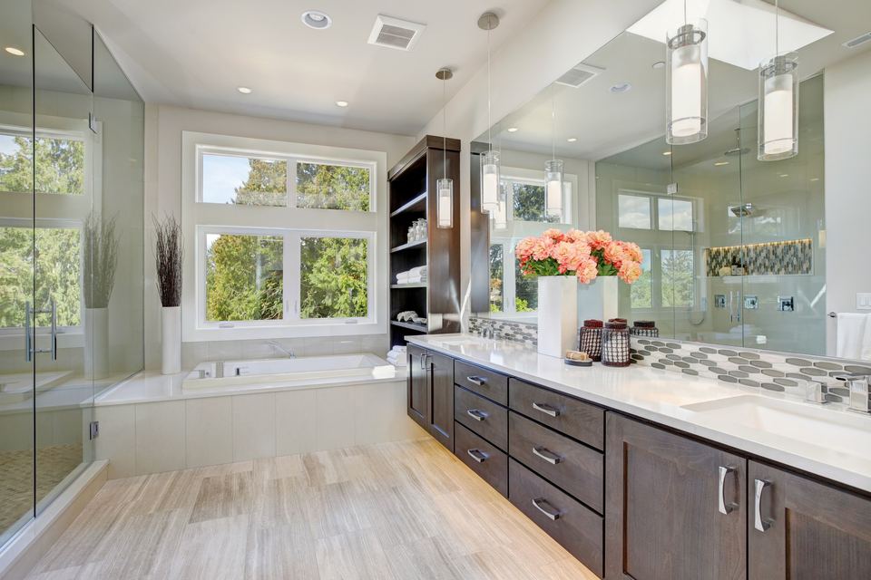 Finished bathroom with a vanity and tub, the kind of room added in a basement remodel
